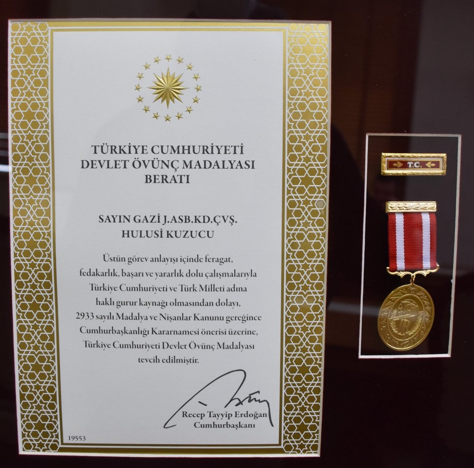 Gazi Kuzucu’ya Devlet Övünç Madalyası Beratı Takdim Edildi